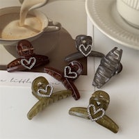 a group of clothes pins with hearts on them