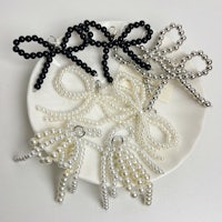 black and white bows with pearls on a plate