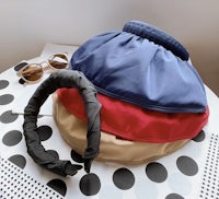 a pair of sunglasses and a bag on top of a polka dot table