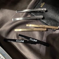four hair clips with the word cline on them