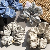 four scrunchies with different designs on them