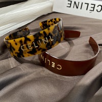 a pair of cuff bracelets with the word ceteled on them