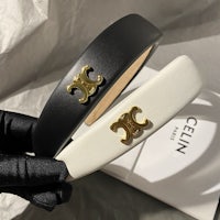 a pair of black and white leather headbands with gold logos