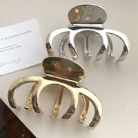 a pair of gold and silver octopus hair clips