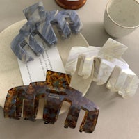 a set of three hair clips on a plate